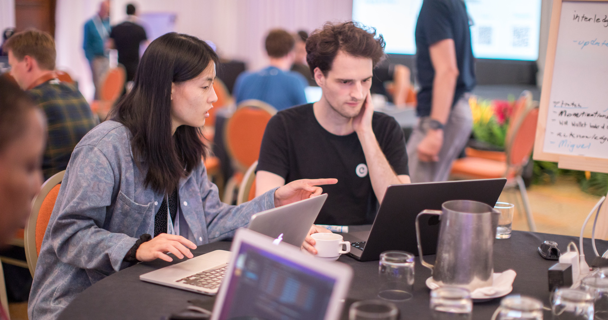 People discuss their solution at an Interledger Hackathon